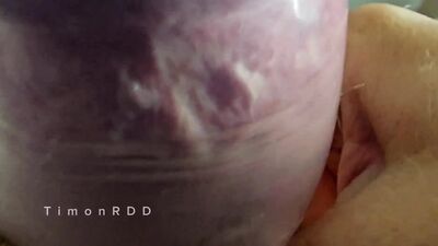 The guy cums in a condom with hot water with powerful volleys