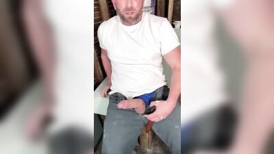Construction worker solo male masturbation on job site.
