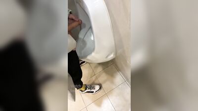 Jerk off a guy's dick in a public toilet. risky
