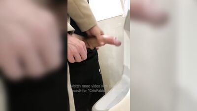 Jerk off a guy's dick in a public toilet. risky