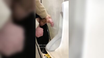 Jerk off a guy's dick in a public toilet. risky