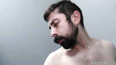 Bearded white man sucking and fucking a black cock at a gloryhole