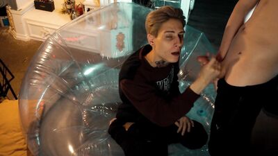 Twin brothers enjoy a romantic moment on the beach while sharing an adorable inflatable chair.