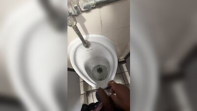 Male models get it on with each other while urinating in the restroom of a popular London hotspot.