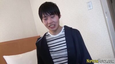 Rewritten as: "A young Japanese man explores his sexuality in an intimate moment of self-pleasure."