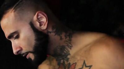 Two burly stallions sandwiching a man in bed