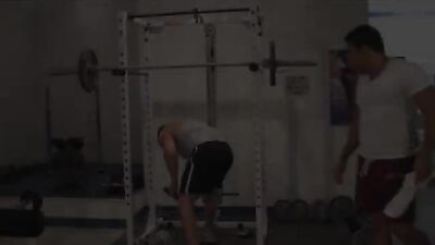 Bodybuilders grunt and flex in the weight room