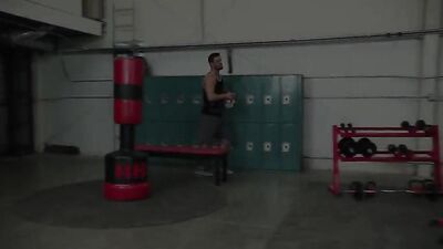 Three gay men in a gym with a fitness coach and two athletes.