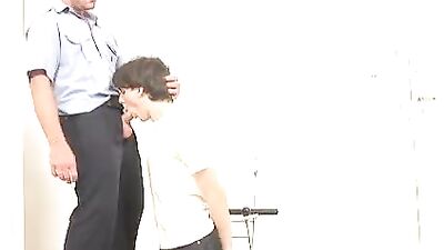 The young man arrested allows himself to be pleasured by the police officer.